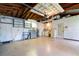 Spacious garage featuring open wood rafters, laundry, and ample storage space at 13898 Jamaica Dr, Seminole, FL 33776