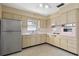 Charming kitchen featuring tiled countertops, vintage oven, and stainless steel refrigerator at 13898 Jamaica Dr, Seminole, FL 33776