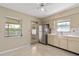Functional kitchen with stainless steel fridge and access to the outdoors at 13898 Jamaica Dr, Seminole, FL 33776