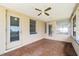 Enclosed lanai featuring tile floors, ceiling fan, and multiple windows at 13898 Jamaica Dr, Seminole, FL 33776