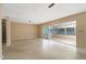 Bright living room with terrazzo flooring and sliding doors to the enclosed lanai at 13898 Jamaica Dr, Seminole, FL 33776