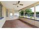 Screened in porch featuring tile flooring, neutral paint, and a ceiling fan for comfortable outdoor living at 13898 Jamaica Dr, Seminole, FL 33776