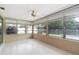 Enclosed patio features many windows, neutral paint, and a ceiling fan at 13898 Jamaica Dr, Seminole, FL 33776