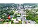 Aerial view of a home in a town with many commercial locations and a street running through the middle at 13917 8Th St, Dade City, FL 33525