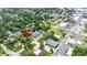 An aerial view of a property close to town and surrounded by lush greenery and neighborhood homes at 13917 8Th St, Dade City, FL 33525