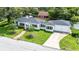 Aerial view of the home showcasing the well-maintained lawn, roof, and surrounding neighborhood at 13917 8Th St, Dade City, FL 33525
