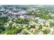 Aerial view of the home within the neighborhood, showcasing its backyard, pool, and proximity to town at 13917 8Th St, Dade City, FL 33525