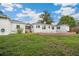 Expansive backyard featuring a swimming pool, brick patio, and lush green lawn at 13917 8Th St, Dade City, FL 33525