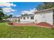 Expansive backyard featuring a swimming pool, brick patio, and lush green lawn at 13917 8Th St, Dade City, FL 33525