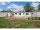 Expansive backyard featuring a swimming pool, brick patio, and lush green lawn at 13917 8Th St, Dade City, FL 33525