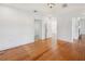 Bedroom with hardwood floors and white walls looking into other rooms at 13917 8Th St, Dade City, FL 33525