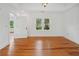 Bedroom featuring hardwood floors, white walls, and a large window at 13917 8Th St, Dade City, FL 33525