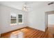 Bright bedroom features gleaming wood floors, crisp white walls, and abundant natural light through double windows at 13917 8Th St, Dade City, FL 33525