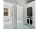 Bonus room features multiple doorways, painted floor, and modern air conditioning unit at 13917 8Th St, Dade City, FL 33525
