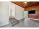 Spacious bonus room features tile flooring, wood paneled ceiling, TV, and view to other rooms at 13917 8Th St, Dade City, FL 33525