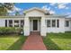 Inviting home entrance with a brick walkway leading to a covered porch at 13917 8Th St, Dade City, FL 33525