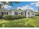 Charming home featuring manicured landscaping, a brick walkway, and a covered front porch at 13917 8Th St, Dade City, FL 33525