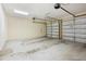 Spacious garage with two white garage doors, fluorescent lighting, and concrete floor at 13917 8Th St, Dade City, FL 33525