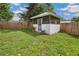 Backyard gazebo surrounded by a wooden fence, featuring a screened entrance at 13917 8Th St, Dade City, FL 33525