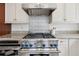 Close-up of the kitchen stove, which features stainless steel and granite countertops at 13917 8Th St, Dade City, FL 33525