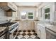 Bright kitchen featuring stainless steel stove and appliances, granite countertops, and checkered flooring at 13917 8Th St, Dade City, FL 33525