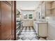 Full kitchen featuring a refrigerator, stainless steel appliances, and checkered flooring at 13917 8Th St, Dade City, FL 33525