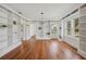 Bright living room with hardwood floors and built-in bookshelves, and large windows at 13917 8Th St, Dade City, FL 33525