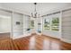 Bright room featuring hardwood floors and built-in bookshelves, and large windows at 13917 8Th St, Dade City, FL 33525