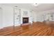 Spacious living room featuring hardwood floors, a brick fireplace, and bookshelves at 13917 8Th St, Dade City, FL 33525