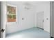 Bright room featuring blue flooring, a window and a mini-split air conditioner at 13917 8Th St, Dade City, FL 33525