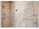 Walk-in shower featuring updated finishes, natural stone, and chrome hardware at 13917 8Th St, Dade City, FL 33525