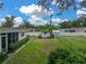 Large backyard featuring a shed, lush lawn, and mature landscaping at 140 Morrow Cir, Brandon, FL 33510