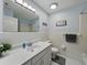Bright bathroom featuring a white tile shower/tub combo and a white vanity with decorative elements at 140 Morrow Cir, Brandon, FL 33510