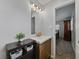 Bathroom with single sink vanity, dark wood cabinets, grey walls, and a view into the main bedroom at 140 Morrow Cir, Brandon, FL 33510