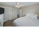 Bedroom with plush carpet, a white ceiling fan, closet and a view into the bathroom at 140 Morrow Cir, Brandon, FL 33510