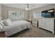 Bedroom featuring large windows with plantation shutters, a ceiling fan, carpet, and white furniture at 140 Morrow Cir, Brandon, FL 33510