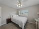 Bright bedroom with large windows, carpet, ceiling fan, and a plush white bedspread at 140 Morrow Cir, Brandon, FL 33510