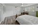 Bedroom features hardwood floors, built in closet, ceiling fan, and a desk under the window at 140 Morrow Cir, Brandon, FL 33510