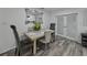 Dining room with contemporary table set, a decorative mirror, and access to the kitchen at 140 Morrow Cir, Brandon, FL 33510