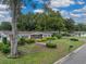 Attractive single story home with a well-kept front yard, lush landscaping, and mature trees on a quiet street at 140 Morrow Cir, Brandon, FL 33510