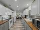 Well-lit kitchen with white cabinetry, butcher block countertops and stainless steel appliances at 140 Morrow Cir, Brandon, FL 33510