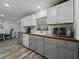 Kitchen featuring white cabinetry, wood countertops, stainless appliances, and a window at 140 Morrow Cir, Brandon, FL 33510