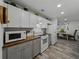 Galley kitchen featuring white cabinetry, butcher block counters, and modern appliances at 140 Morrow Cir, Brandon, FL 33510