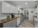 Updated kitchen featuring butcher block counters and white and gray cabinets and hardwood floors at 140 Morrow Cir, Brandon, FL 33510