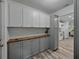 Kitchen featuring butcher block counters, white cabinets, gray lower cabinets and hardwood floors at 140 Morrow Cir, Brandon, FL 33510