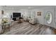 Spacious living area with neutral decor, wood-look floors, comfortable seating and a decorative front door at 140 Morrow Cir, Brandon, FL 33510