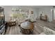 Open living room with plank flooring and matching floral sofa and chairs near the front entrance at 140 Morrow Cir, Brandon, FL 33510