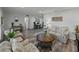 Open-concept living area with plank floors, contemporary furnishings, and bright, natural light at 140 Morrow Cir, Brandon, FL 33510