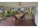 Screened-in porch providing scenic views of the backyard, furnished with a dining table at 140 Morrow Cir, Brandon, FL 33510
