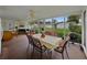 Spacious screened-in porch offering multiple seating areas, BBQ, and backyard views for relaxed living at 140 Morrow Cir, Brandon, FL 33510
